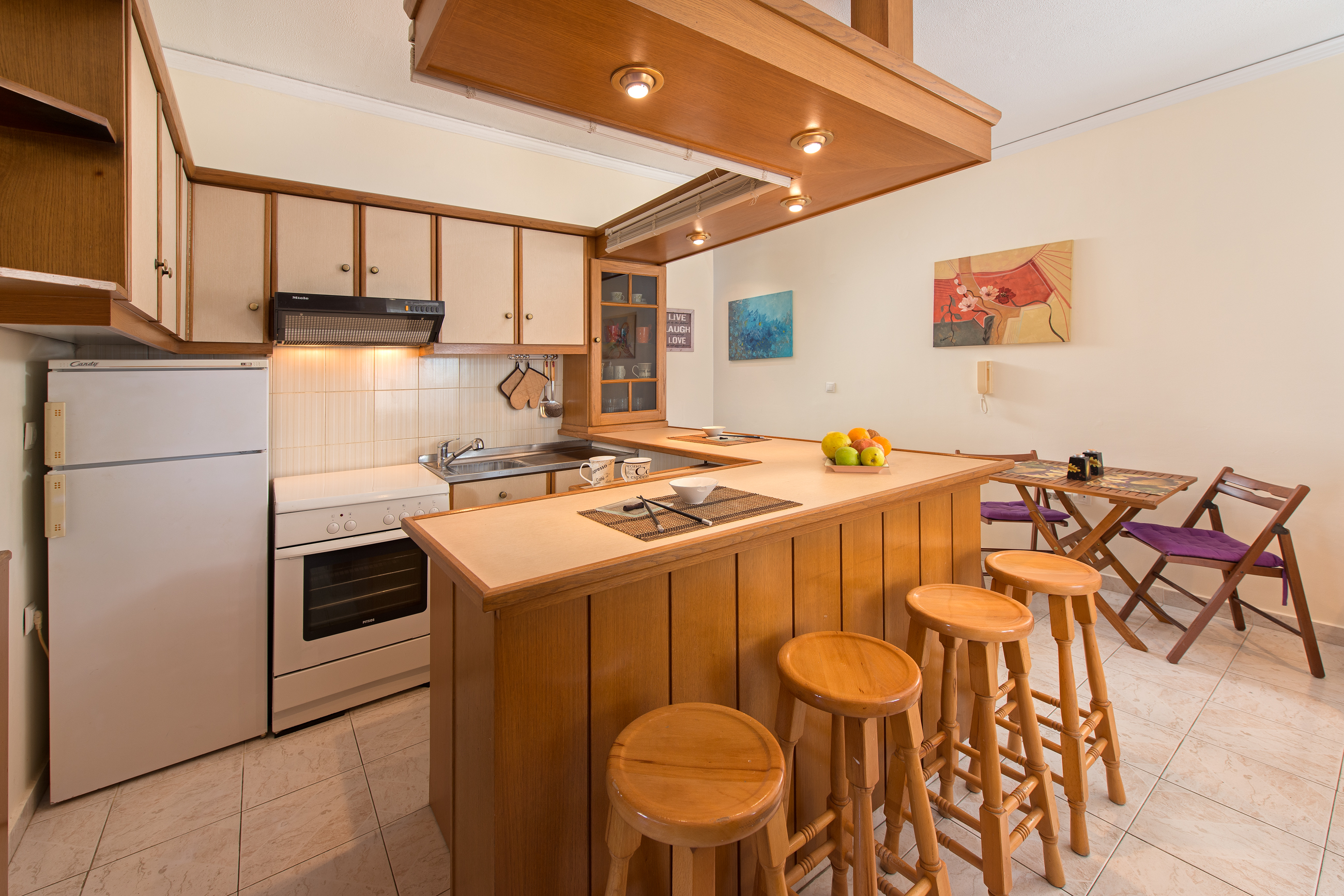Fully equipped open-plan kitchen with breakfast bar